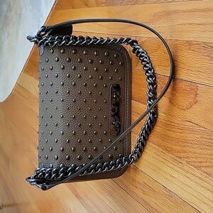 Coach handbag in pebbled leather and studded detail.